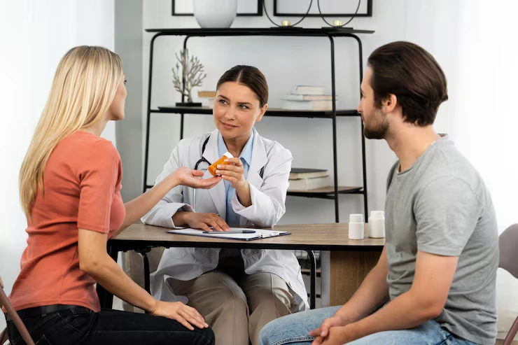 side-view-young-couple-talking-doctor_23-2149485509